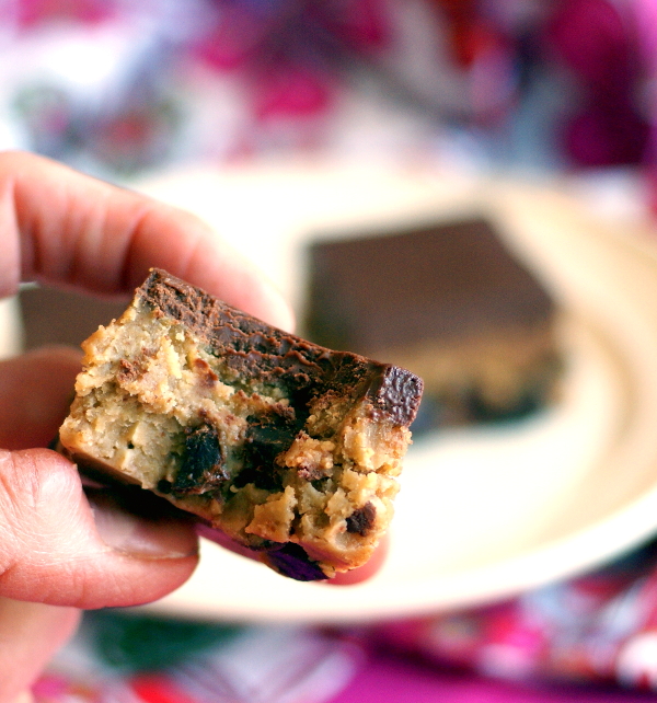 Gooey, chocolate-studded candida-diet friendly cookie dough bar with a big bite taken out