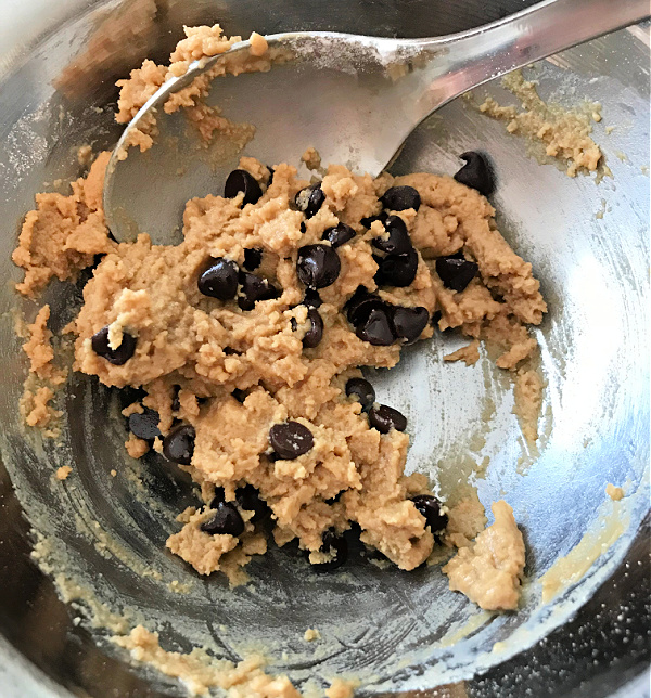 spoon in a bowl of chocolate chip cookie dough
